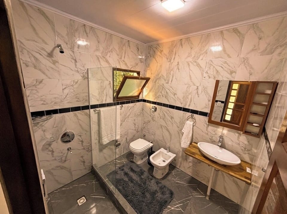 Premium Suite, Pool View | Bathroom | Shower, bidet, towels, soap