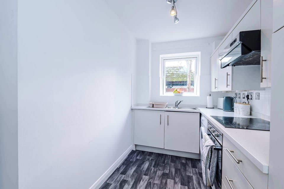 Bright and airy kitchen: Whip up delicious meals with modern appliances and a sunny window view!