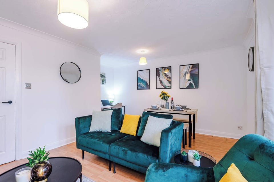 Living Room: Vibrant seating and modern art create a stylish retreat for relaxation and fun!