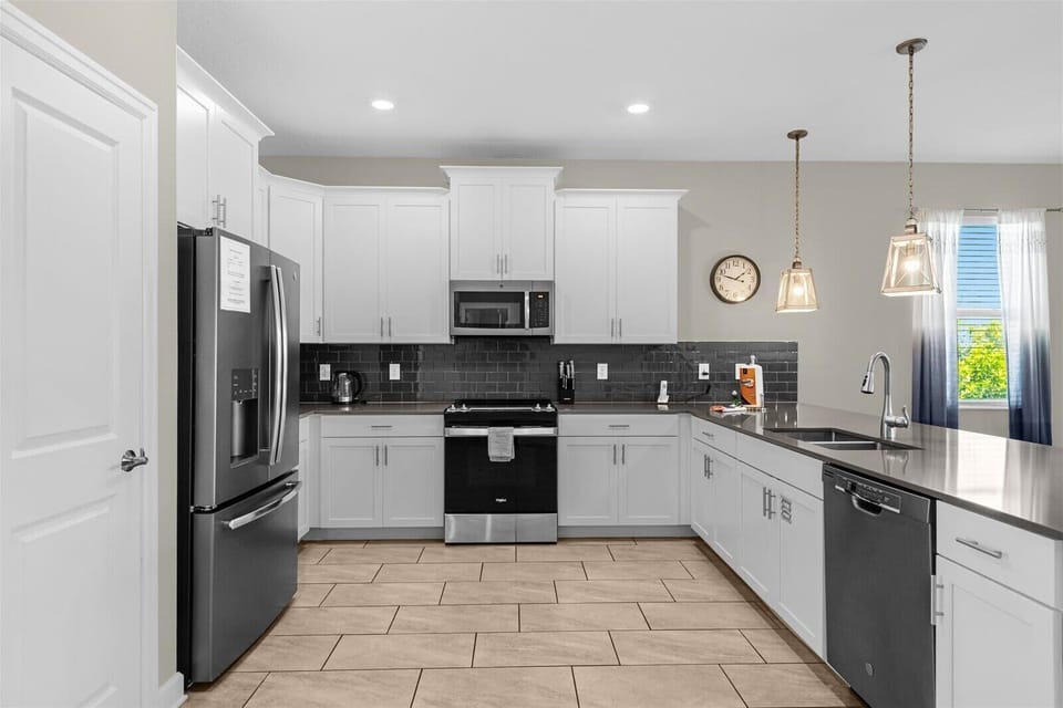 Fully equipped kitchen with modern appliances, ample counter space, and everything needed for family meals.