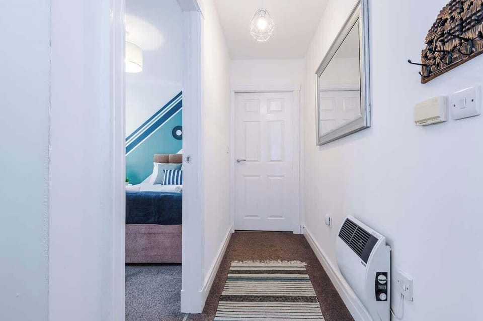 Hallway: Bright and inviting entrance leading to your stylishly designed retreat!