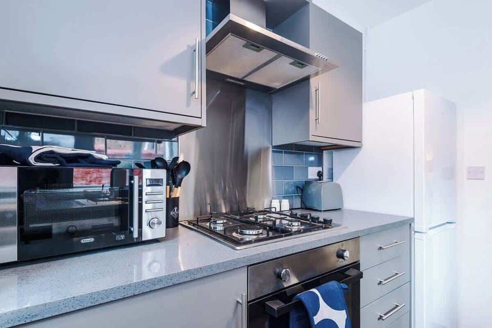 Kitchen: Modern design with sleek appliances and a pop of color for your culinary adventures!