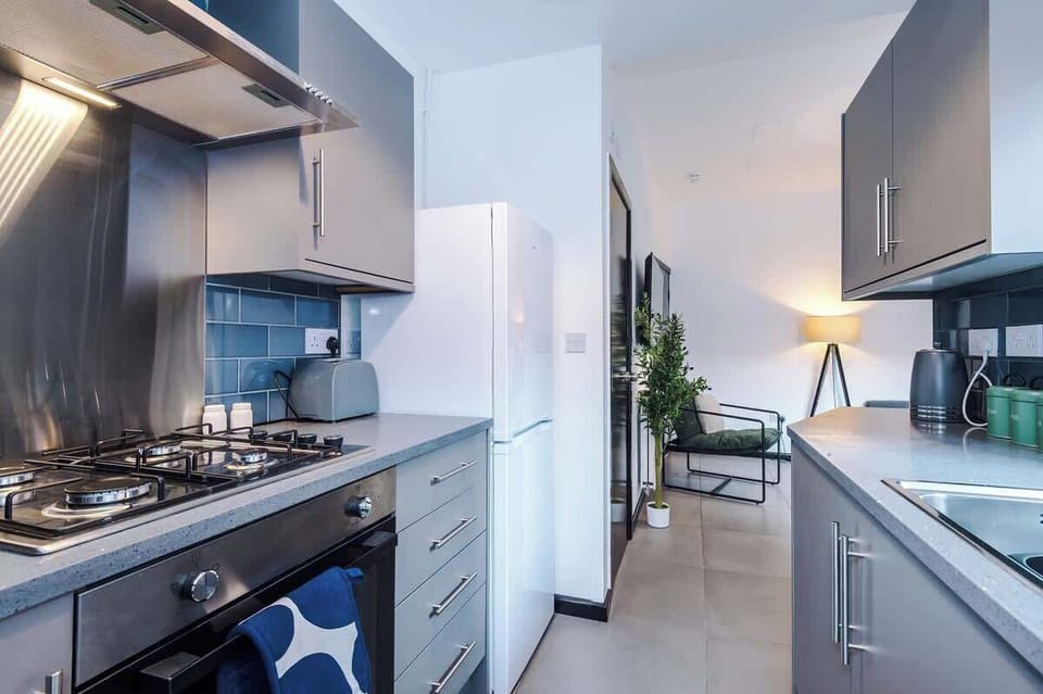Kitchen: Modern design with sleek appliances and a pop of color for your culinary adventures!