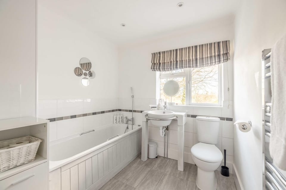 Bathroom Retreat: Bright and modern with natural light, perfect for your refreshing escape!