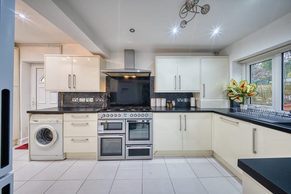 Modern Kitchen: Culinary adventures await in this stylish space with sleek appliances and vibrant decor!