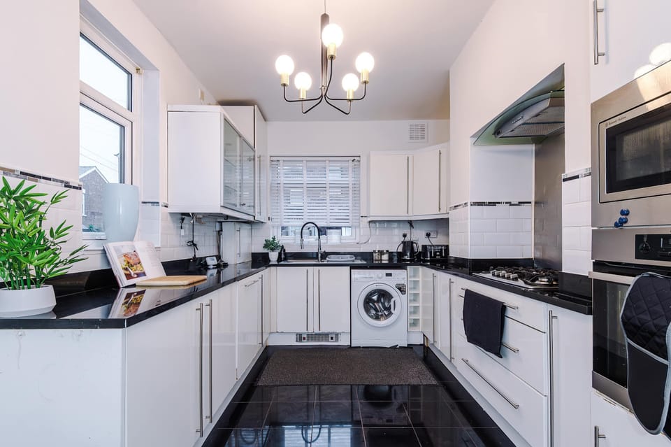 Modern Kitchen: Stylish space with chic lighting and sleek appliances for culinary adventures!
