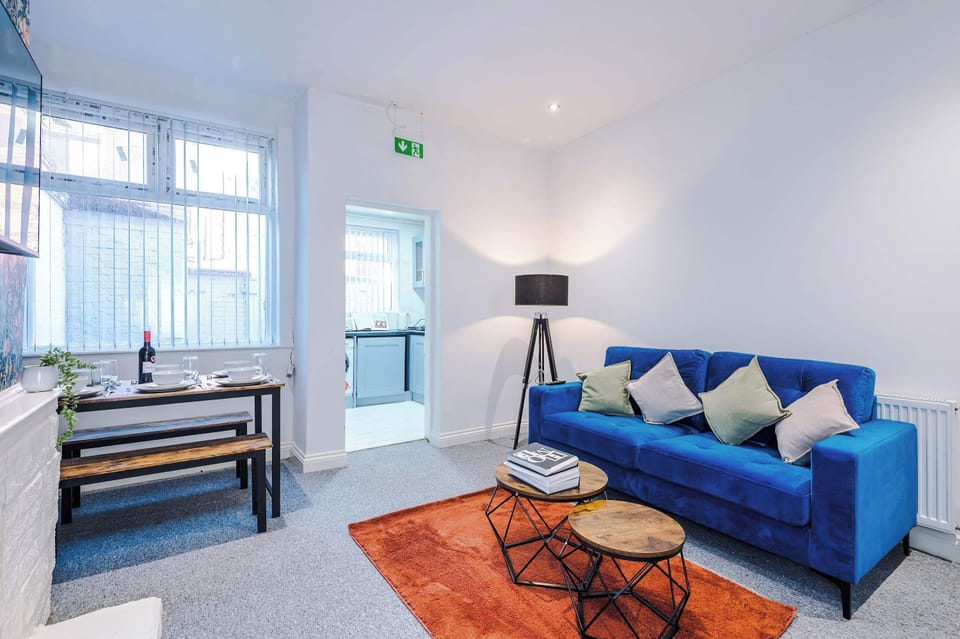 Living Room: Bright space with stylish blue sofa, perfect for relaxation and gatherings!