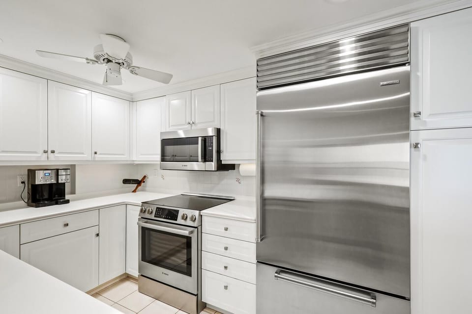 Sleek modern kitchen with stainless steel appliances and bright cabinetry