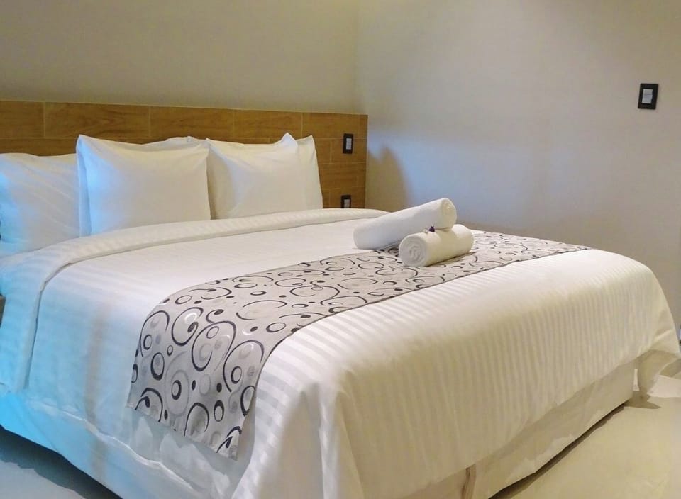 Drift off on a plush king bed with fresh hotel linens.