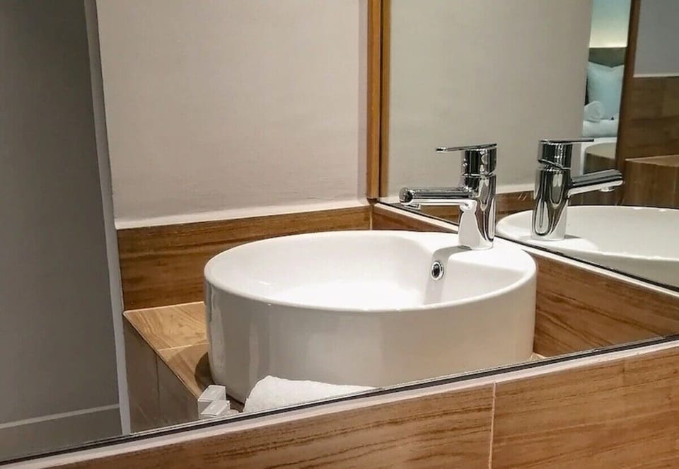 Refresh at a modern vanity with bright mirror lighting.