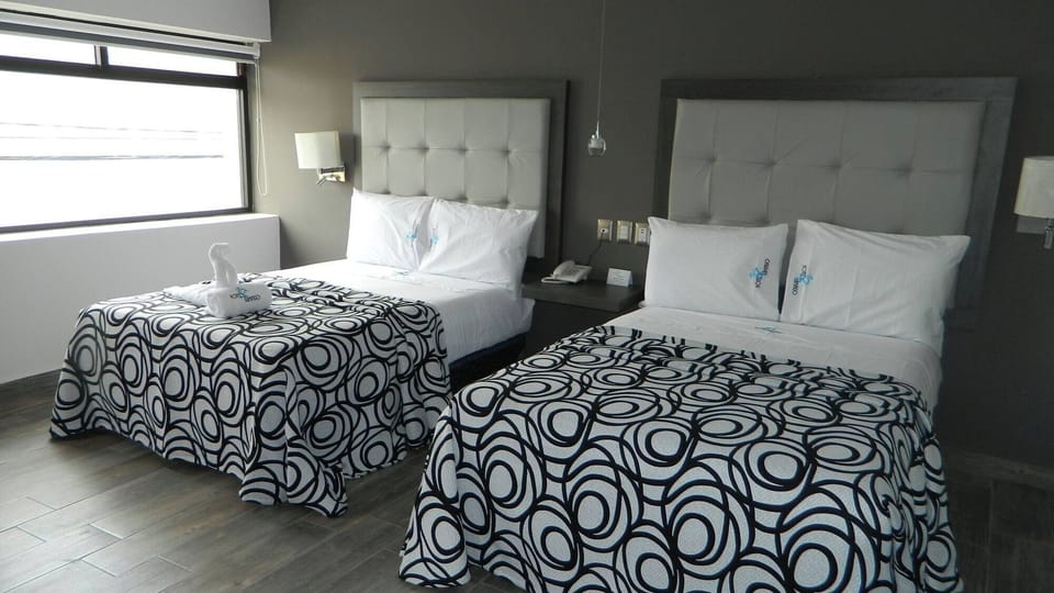 Wake up to sunshine beside cozy double beds and soft pillows.