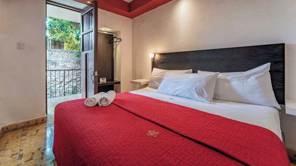 Unwind on the plush king bed beside breezy balcony doors