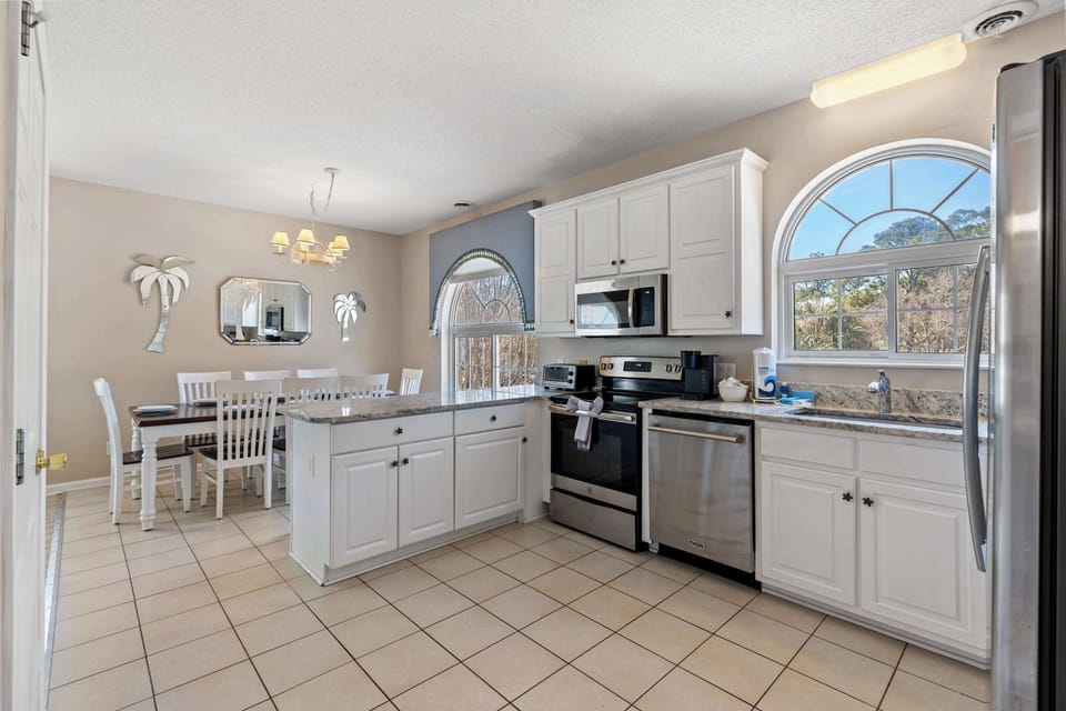 Fully stocked kitchen with stainless appliances and ample prep space