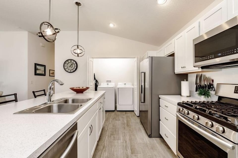Fully stocked kitchen with large size  washer and dryer