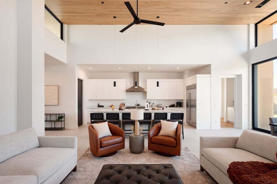 Bright and open living area featuring plush furnishings, a smart TV, and a fireplace.