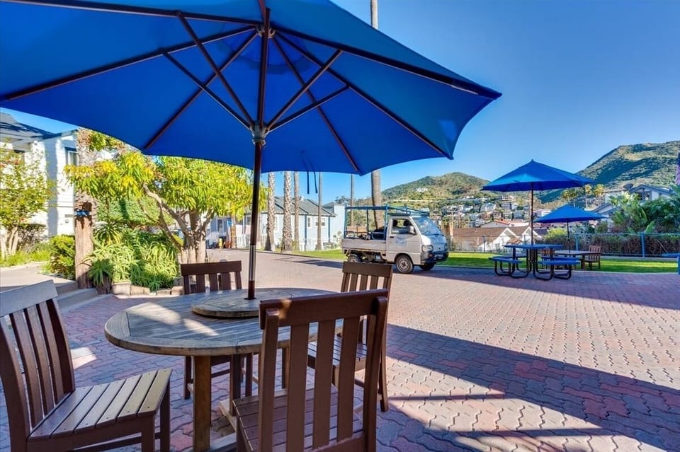 Gather outside for coffee under bright umbrellas and sunshine.