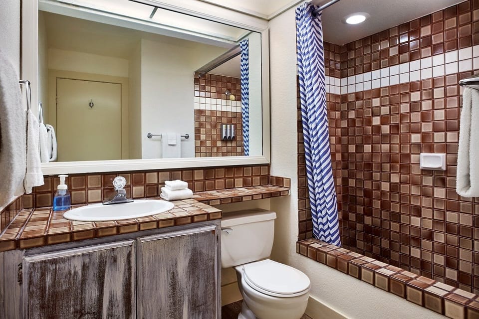Refresh after adventures with a bright vanity and tiled shower.