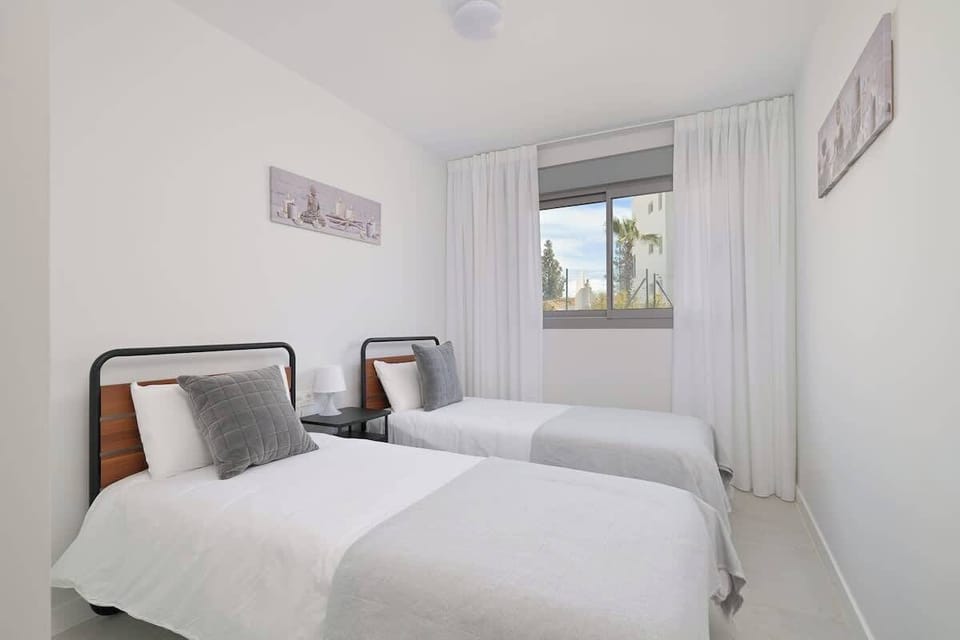 Two comfortable single beds that can be arranged separately or pushed together to create a larger double bed, giving guests flexible sleeping options.