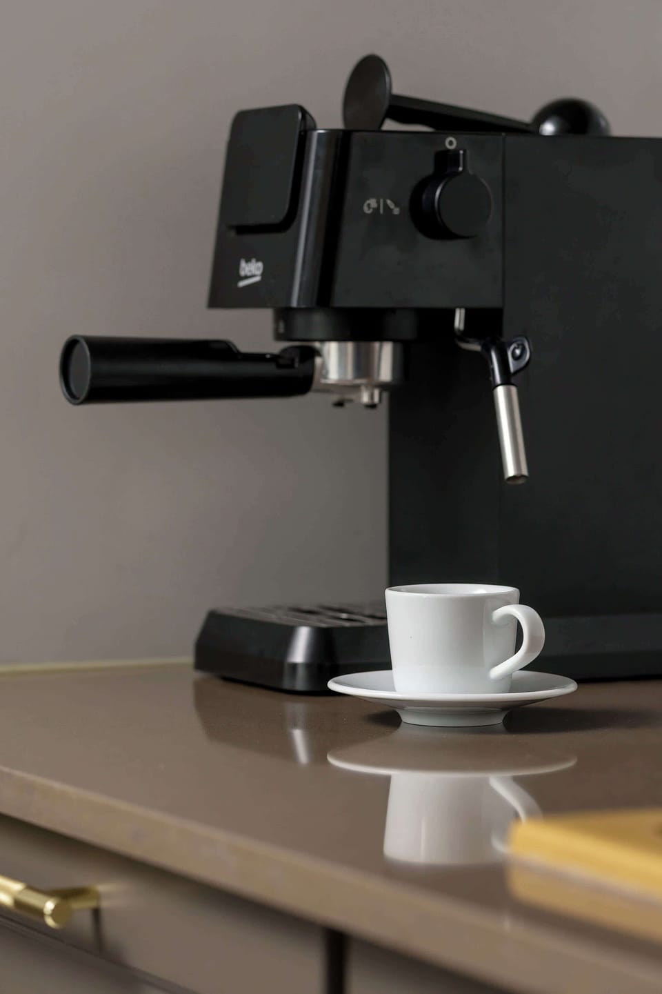 Close-up of the kitchen counter and the coffee machine placed on it.