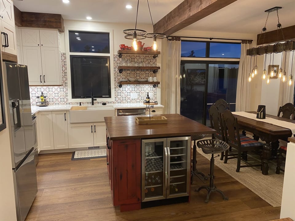 Kitchen island showing dining table and doors to outside balcony
