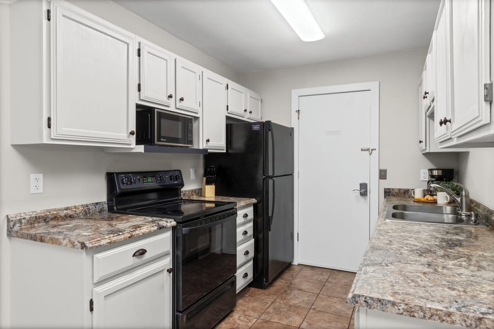 Your fully equipped kitchen awaits with granite countertops, modern appliances, and ample cabinet space for preparing memorable meals during your stay.
