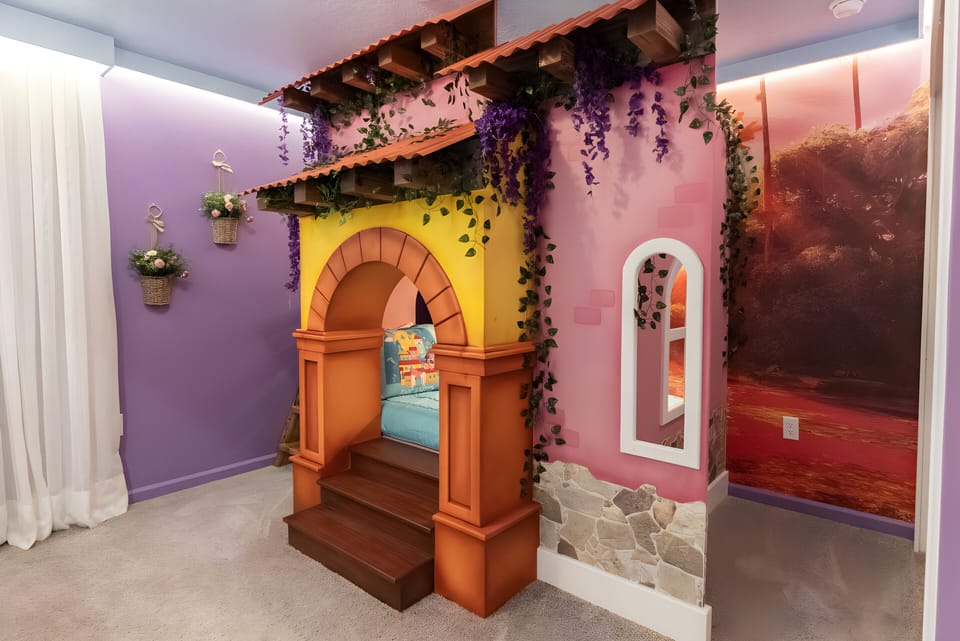 Step into a whimsical hideaway featuring a vibrant archway adorned with cascading greenery, inviting you to explore. The playful purple walls and colorful decor create a cheerful atmosphere, perfect for relaxation and fun.