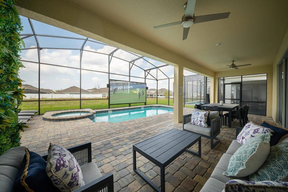 Unwind in our spacious outdoor lounge with stylish seating by the refreshing pool. Enjoy entertainment on large screens or soak in serene views, all set on a textured stone patio for the ultimate al fresco experience.
