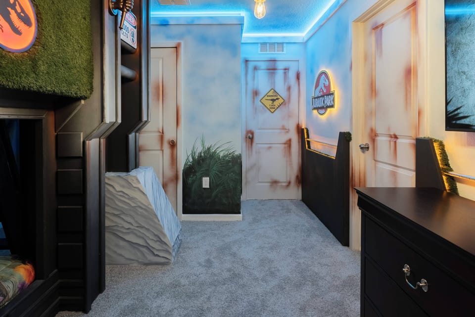 Welcome to a uniquely themed room where vibrant blue LED lights create a playful atmosphere. The whimsical wall art and plush carpet invite relaxation after your day's adventures, making it perfect for kids and the young at heart.