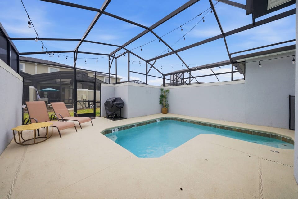 Welcome to your private oasis with a sparkling pool and spacious patio, ideal for lounging on chic chaise chairs. The screened enclosure creates a breezy atmosphere, perfect for relaxing under the sunny skies. Enjoy your getaway!