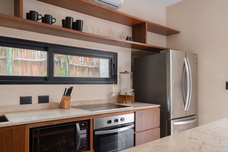 A modern kitchen with warm wood details, fully equipped for easy meals.