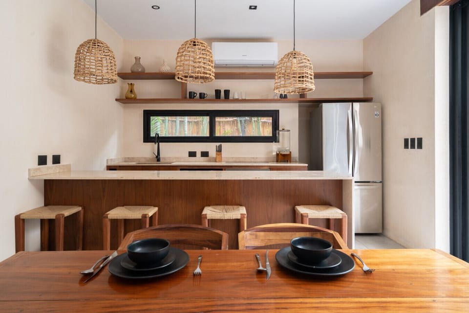 Elegant kitchen bar with stone countertops, wood accents, and handcrafted stools.
