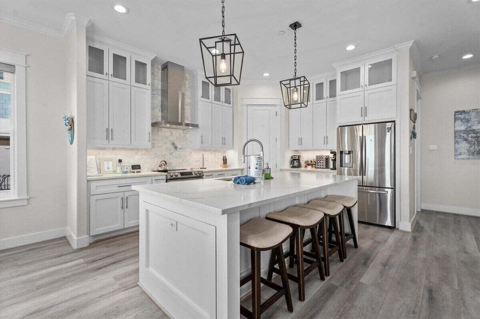 Spacious chef's kitchen with oversized island and stainless appliances in the beachfront Galveston home.