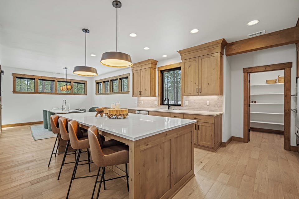 Gather around this stunning kitchen island where warm wood meets modern elegance, perfect for your morning coffee or evening meals together.