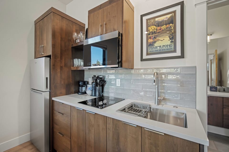 Your fully equipped kitchen features warm wood cabinetry, sleek appliances, and everything you need to create delicious meals during your stay.