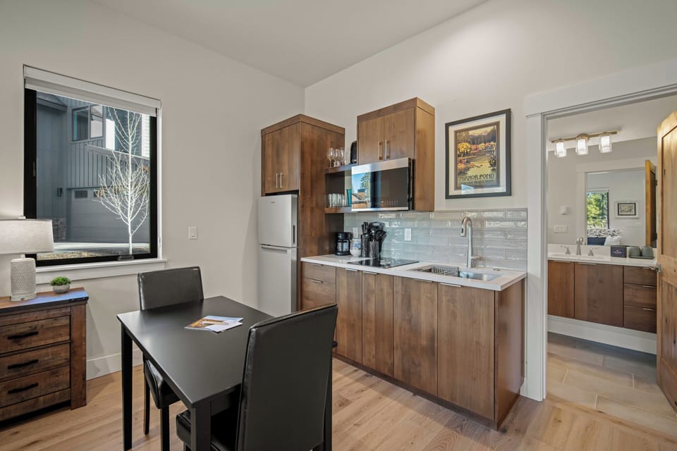 Your modern kitchen invites culinary creativity with sleek appliances, warm wood cabinetry, and elegant countertops perfect for cooking memorable meals.