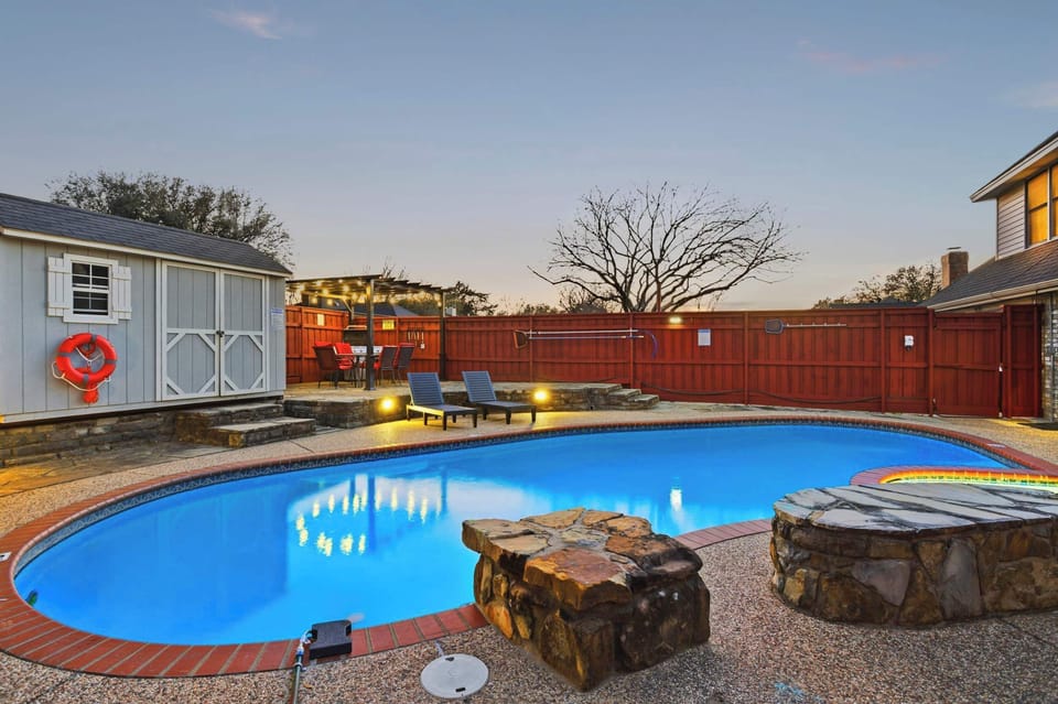 Relax in your private oasis featuring a pool, patio sent, and a shaded pergola.