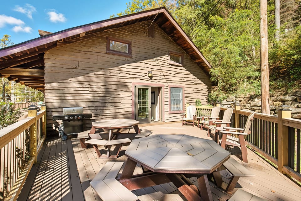 The expansive deck is ideal for gatherings, complete with ample seating and a barbecue grill for outdoor cooking.