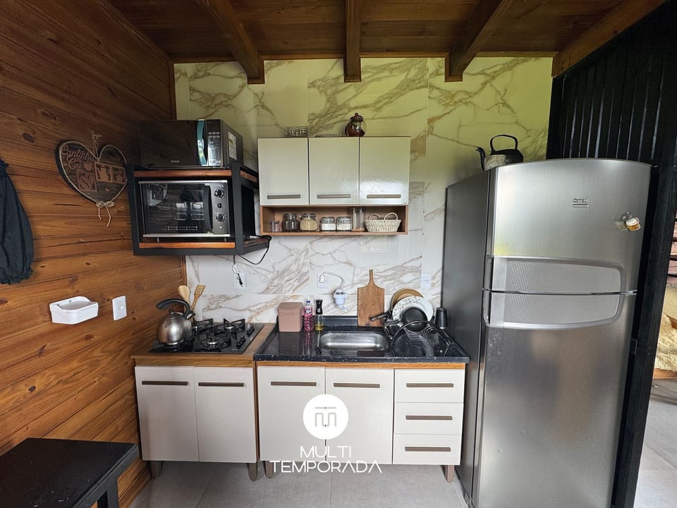 Deluxe Chalet, Jetted Tub, Mountain View | Private kitchen | Fridge, microwave, cookware/dishes/utensils, dining tables