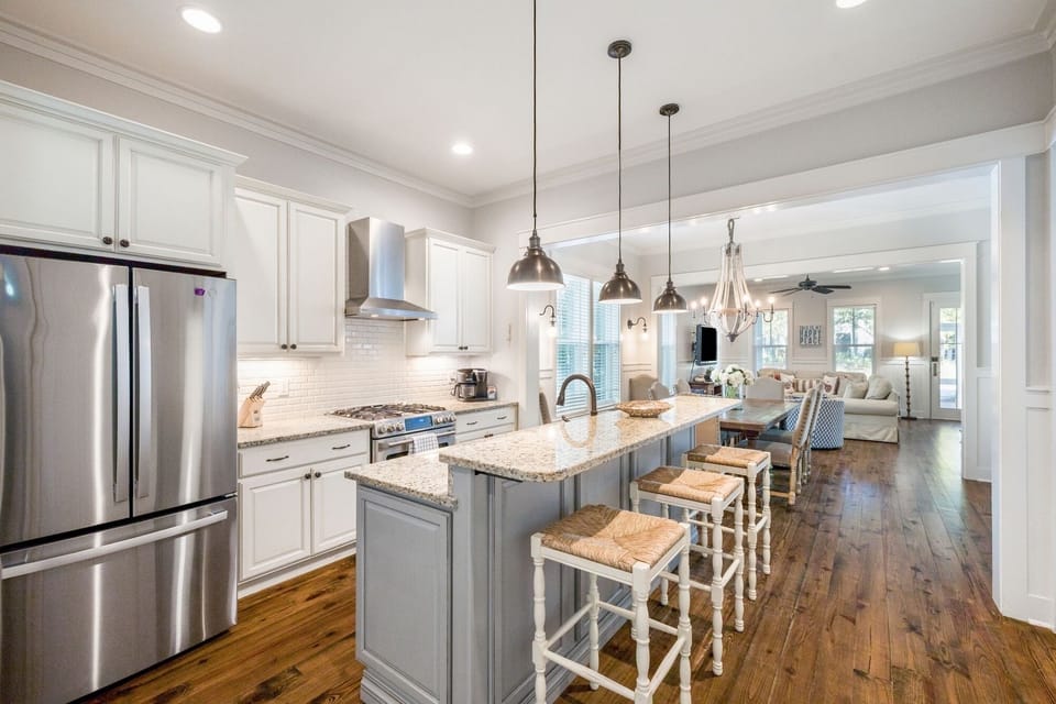 Your gourmet kitchen features granite counters, stainless appliances, and a spacious island perfect for morning coffee or evening wine.