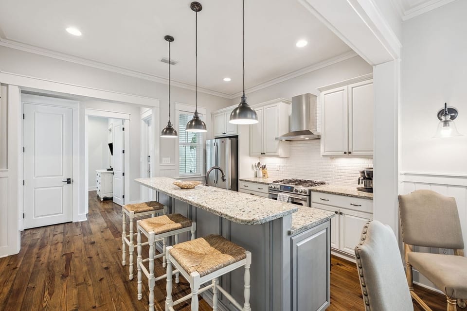 Cook up memories in this bright, spacious kitchen featuring gleaming granite counters, modern appliances, and cozy island seating.