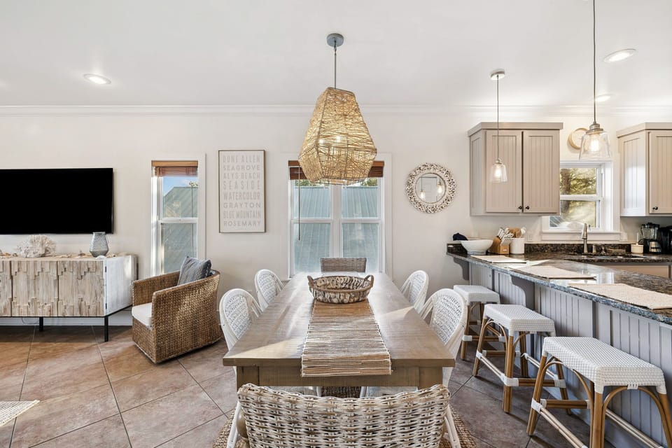 Gather around your spacious dining table where natural textures and coastal charm create the perfect setting for memorable meals together.