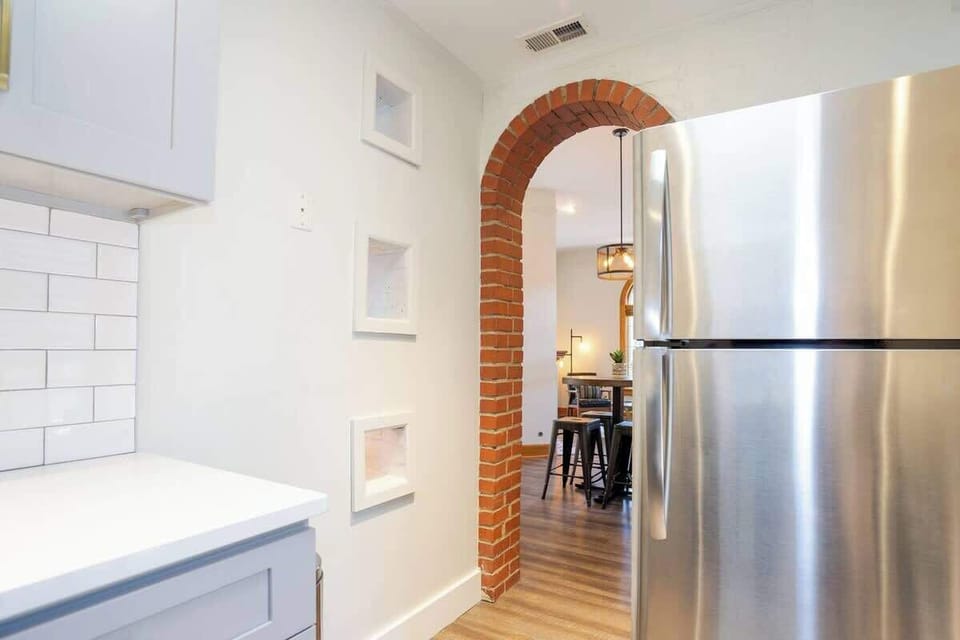The open layout allows whoever is in the kitchen to have a conversation with the people sitting at the dining table.