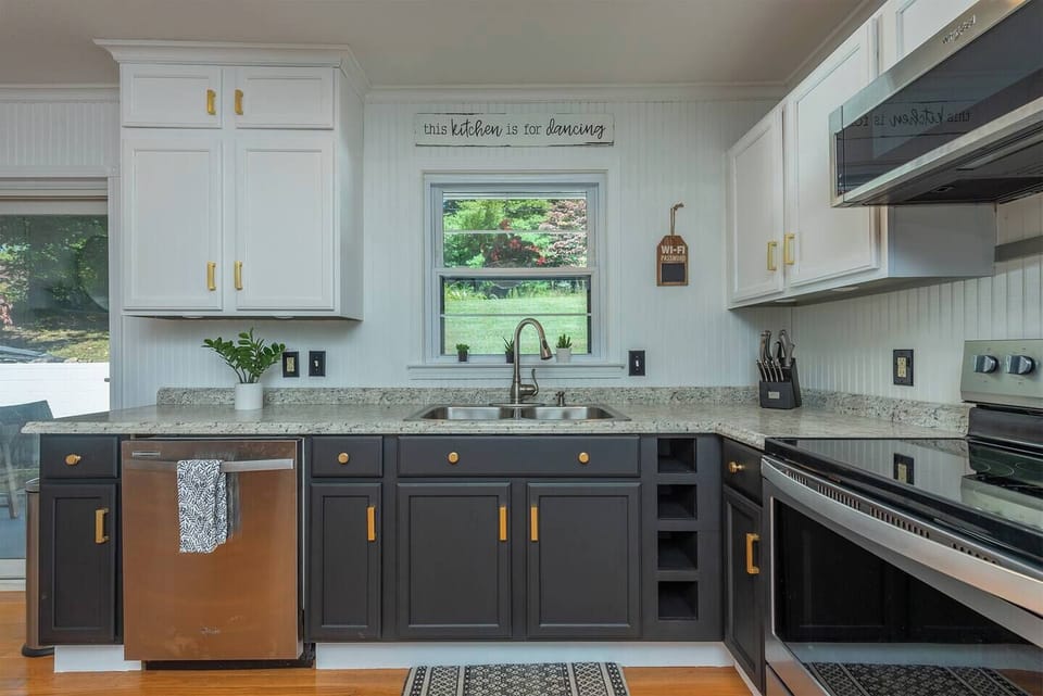 Cook with a view: stainless appliances, granite counters, and windows overlooking the yard.