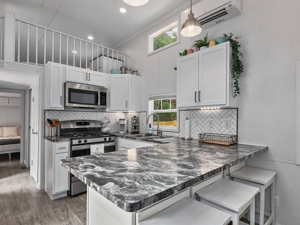 Bright modern kitchen with a large island, bar seating, and everything needed for hosting meals and gatherings