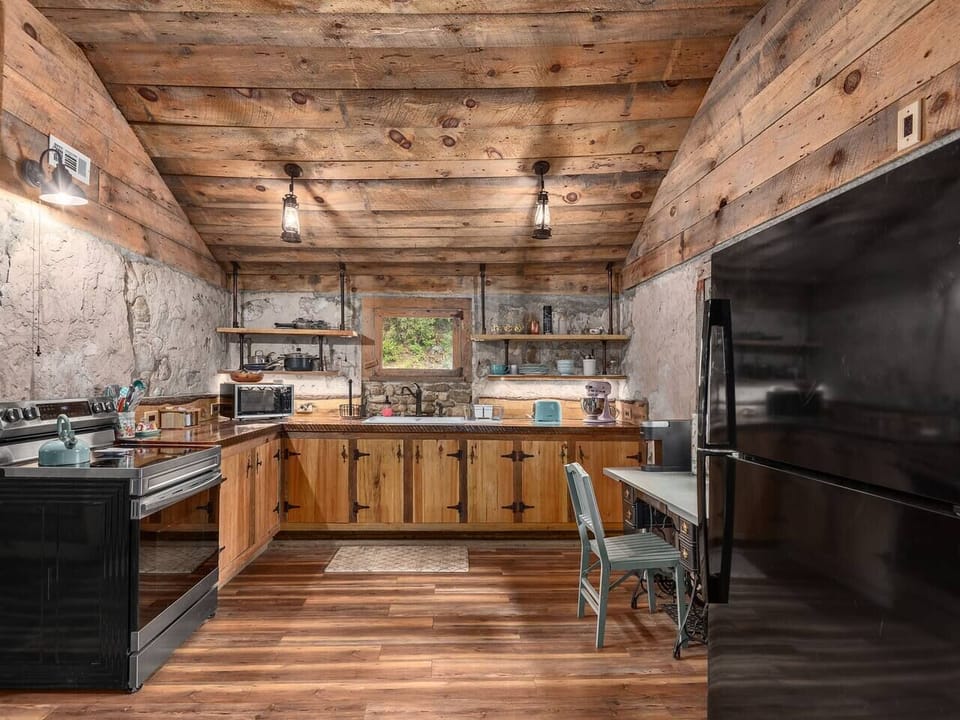 Rustic-style kitchen with wood finishes, modern appliances, and plenty of room for preparing group meals
