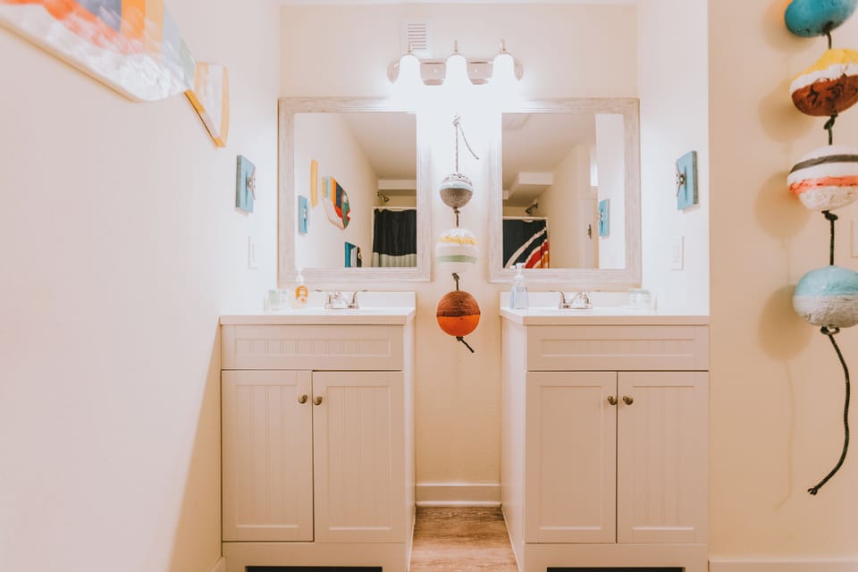 Bathroom with 2 shower stalls, 2 toilet stalls and added shelving not pictured