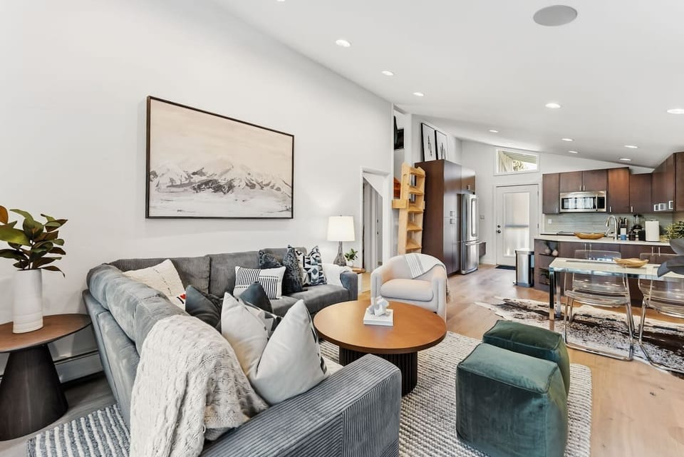 Beautifully renovated living room with fireplace, smart TV, a walkout balcony and plenty of natural light