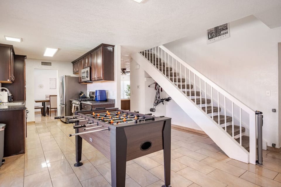 Spacious living area with foosball table and staircase - fun entertainment for the whole family.