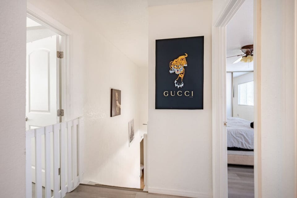 Hallway with stylish wall art and access to bedrooms