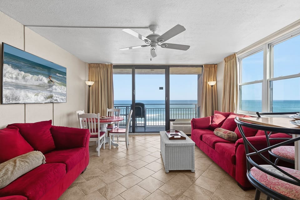 Take in breathtaking Gulf views from this bright oceanfront living room with private balcony access. Featuring comfortable seating and coastal charm, this beach stay vacation rental is perfect for relaxing after a day on the sand.